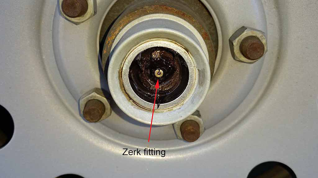 ... Cover removed exposing Zerk fitting the center of the axle ...